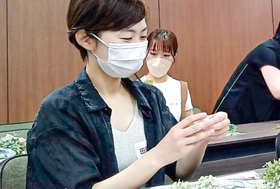 レクリエーションでフラワーアレンジメントに挑戦する参加者（撮影・小林）