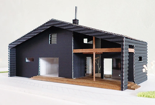 通り抜けできるウッドデッキのアプローチが印象的な家の模型
