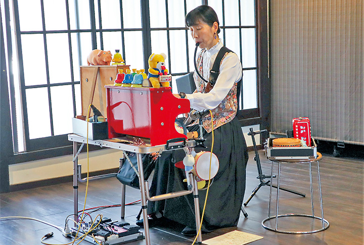 おもちゃの楽器で「愛の花」などを奏でる演奏者（撮影・山北）