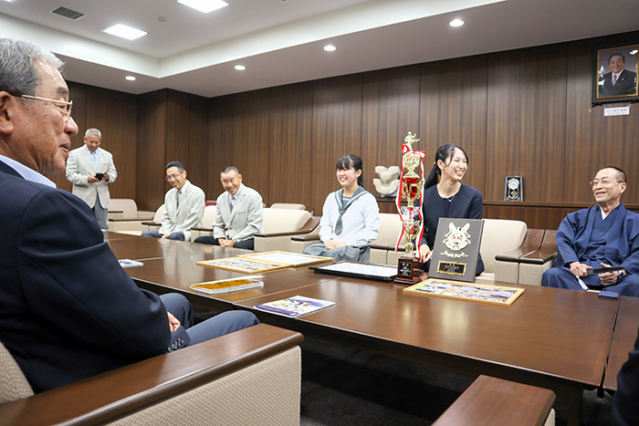 高垣市長（手前）に優勝報告をする（右から）正木英雄本部長、古屋さん、折出さんら関係者