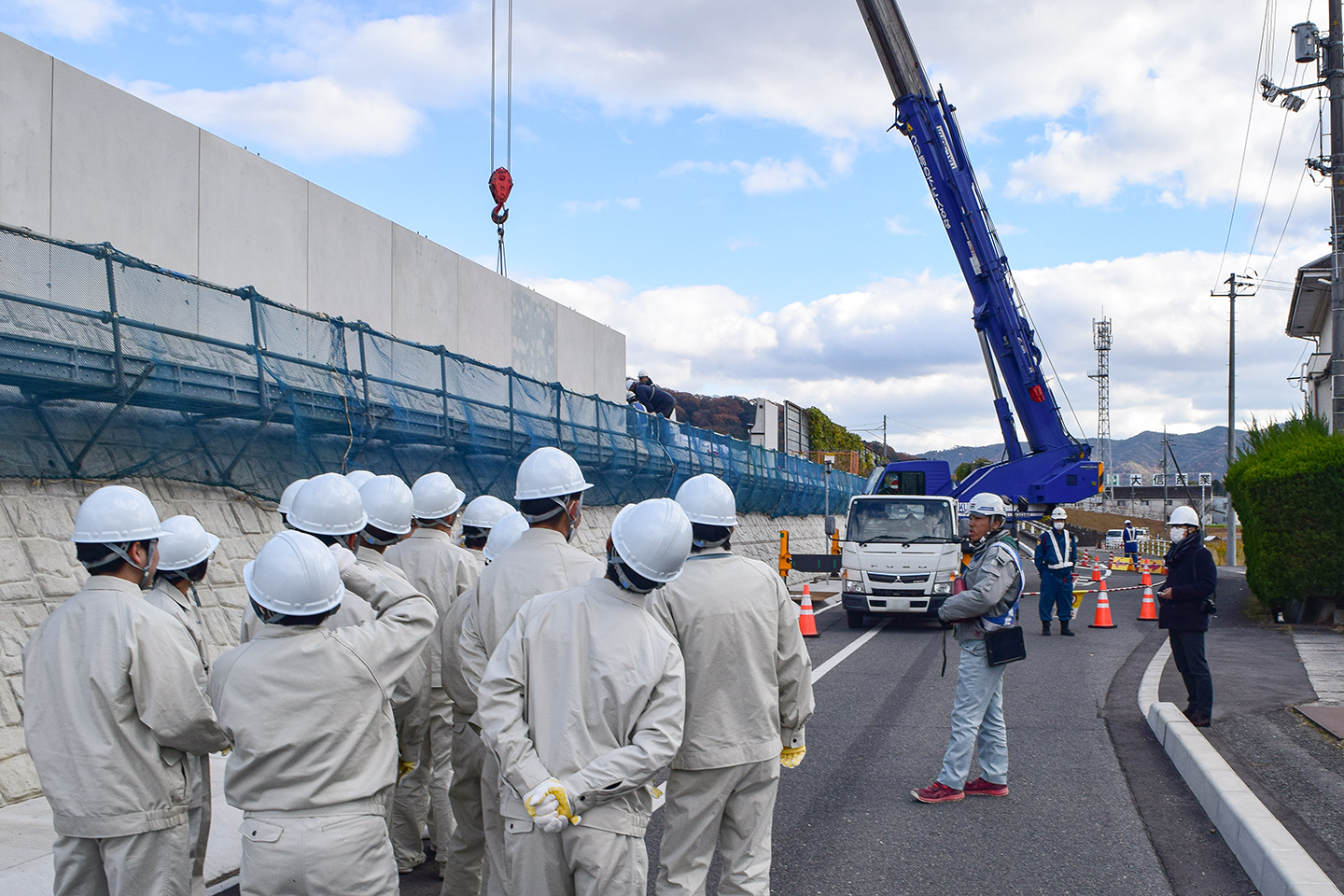 L型ブロックの施工状況を見学する西条農高生ら(提供写真)